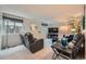 Cozy living room area with plush seating, plants, and natural light from the window at 4349 S Genoa Ct, Centennial, CO 80015
