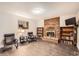 Finished basement recreation area with fireplace and built-in shelving at 1584 S Vaughn Cir, Aurora, CO 80012