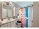 Bathroom with shower/tub combo and colorful decor at 1584 S Vaughn Cir, Aurora, CO 80012