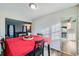 Dining area with red tablecloth, wooden chairs, and view of living room at 1584 S Vaughn Cir, Aurora, CO 80012