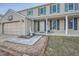 House exterior featuring a two-car garage and a landscaped front yard at 1584 S Vaughn Cir, Aurora, CO 80012