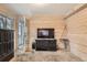 Cozy Gathering room with wood-paneled walls, a TV, and built-in shelving at 1584 S Vaughn Cir, Aurora, CO 80012