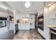 Well-lit kitchen with white cabinets and stainless steel appliances at 1584 S Vaughn Cir, Aurora, CO 80012