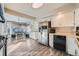 White kitchen with stainless steel appliances and wood-look flooring at 1584 S Vaughn Cir, Aurora, CO 80012