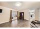 Spacious living room with tile floors, French doors, and kitchen views at 1584 S Vaughn Cir, Aurora, CO 80012