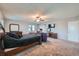 Large main bedroom with two seating chairs and a ceiling fan at 1584 S Vaughn Cir, Aurora, CO 80012