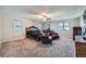 Spacious main bedroom with a sitting area and ceiling fan at 1584 S Vaughn Cir, Aurora, CO 80012