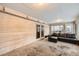 Bright sunroom features wood walls, a comfy sectional sofa, and ample natural light at 1584 S Vaughn Cir, Aurora, CO 80012