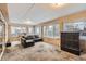 Relaxing sunroom with L-shaped sofa, and views of the backyard at 1584 S Vaughn Cir, Aurora, CO 80012