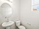 Simple bathroom with a pedestal sink and a toilet at 8888 Salida St, Commerce City, CO 80022