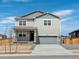 Two-story house with gray siding, stone accents, and a two-car garage at 8888 Salida St, Commerce City, CO 80022