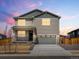 Two-story house with gray siding, stone accents, and a two-car garage at 8888 Salida St, Commerce City, CO 80022