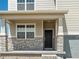 Inviting front entrance with stone accents and a dark-stained front door at 8888 Salida St, Commerce City, CO 80022