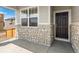 Front entrance with stone detailing and a dark wood door at 8888 Salida St, Commerce City, CO 80022