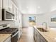 Bright kitchen featuring stainless steel appliances and an island at 8888 Salida St, Commerce City, CO 80022