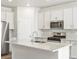 Modern kitchen with white cabinets and granite island at 8888 Salida St, Commerce City, CO 80022