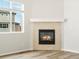 Living room with corner fireplace and wood-look floors at 8888 Salida St, Commerce City, CO 80022