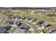 An aerial shot of a residential area with various house models, green spaces, and visible community amenities at 23883 E Minnow Cir, Aurora, CO 80016