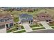 An aerial view of a well-maintained home featuring a two-car garage, beautiful landscaping, and a fenced backyard at 23883 E Minnow Cir, Aurora, CO 80016