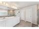 Well-lit bathroom featuring a double sink vanity, a large mirror, a tiled floor, and a walk-in shower at 23883 E Minnow Cir, Aurora, CO 80016