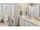 Bright bathroom featuring a white vanity, round mirrors with coastal decor, and a shower-tub combo with a tiled floor at 23883 E Minnow Cir, Aurora, CO 80016