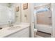 Bathroom with a white vanity, framed mirror, decorative accents, and a shower-tub combo with a window at 23883 E Minnow Cir, Aurora, CO 80016