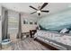 Comfortable bedroom with a scenic mountain mural, a twin bed, a ceiling fan, and storage for an inspiring retreat at 23883 E Minnow Cir, Aurora, CO 80016
