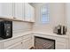 Butler's pantry with white cabinetry, countertop space, and wine storage at 23883 E Minnow Cir, Aurora, CO 80016