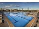 Large swimming pool with lounge chairs and pergola in a well-maintained community area at 23883 E Minnow Cir, Aurora, CO 80016