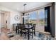 Dining room with a modern light fixture, area rug, and an exterior view through the window at 23883 E Minnow Cir, Aurora, CO 80016