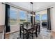A dining area features modern lighting, and sliding glass doors offering outdoor views at 23883 E Minnow Cir, Aurora, CO 80016