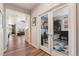 Inviting home foyer with hardwood floors, leading to a living room and an office with glass doors at 23883 E Minnow Cir, Aurora, CO 80016