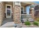 Close-up of a porch with stone pillars, Ring security system, and a view of the neighborhood at 23883 E Minnow Cir, Aurora, CO 80016