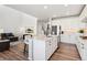 Bright kitchen features a large island, stainless steel appliances, and stylish countertops at 23883 E Minnow Cir, Aurora, CO 80016