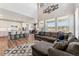 Open-concept living room with a large sectional sofa, flowing into the dining and kitchen areas at 23883 E Minnow Cir, Aurora, CO 80016