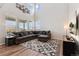 Spacious living room with large windows, hardwood floors, and comfortable seating at 23883 E Minnow Cir, Aurora, CO 80016
