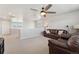 A cozy loft with seating area, ceiling fan, and plenty of natural light at 23883 E Minnow Cir, Aurora, CO 80016
