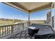 Covered patio with a comfortable outdoor seating area offering views of the neighborhood and open space at 23883 E Minnow Cir, Aurora, CO 80016