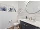 Stylish powder room with modern vanity, round mirror, and shiplap accent wall at 23883 E Minnow Cir, Aurora, CO 80016