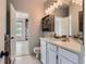 Bathroom with white vanity, light fixtures, and tile flooring at 3040 W Prentice Ave # B, Littleton, CO 80123