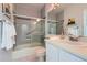 Bathroom featuring tiled shower, glass doors, and white vanity at 3040 W Prentice Ave # B, Littleton, CO 80123