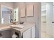 Bathroom vanity area with white cabinetry, mirror, and neutral decor at 3040 W Prentice Ave # B, Littleton, CO 80123