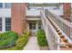 Home exterior with brick and white siding, a walkway, stairs, and nice landscaping at 3040 W Prentice Ave # B, Littleton, CO 80123
