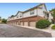 Long shot of multiple garages on a brick and white-sided building on a paved parking area at 3040 W Prentice Ave # B, Littleton, CO 80123