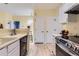 Open kitchen design with modern appliances and convenient access to the dining area at 3040 W Prentice Ave # B, Littleton, CO 80123