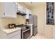 Modern kitchen with stainless steel appliances, bright countertops and white cabinetry at 3040 W Prentice Ave # B, Littleton, CO 80123