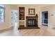 Living room with light yellow walls, hardwood floors and a brick fireplace at 3040 W Prentice Ave # B, Littleton, CO 80123