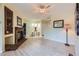 Open living space with wood floors and a brick fireplace, seamlessly flowing into the dining area at 3040 W Prentice Ave # B, Littleton, CO 80123