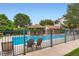A community pool surrounded by a fence, trees, and a gazebo at 3040 W Prentice Ave # B, Littleton, CO 80123