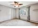Neutral bedroom featuring a window, plush carpeting, and baseboard trim at 13500 E Cornell Ave # 302, Aurora, CO 80014